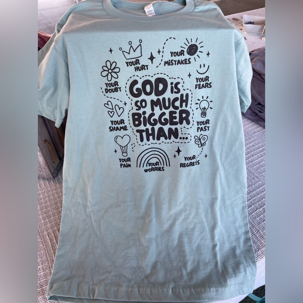 God is Bigger than. Cotton shirt so will shrink a little.